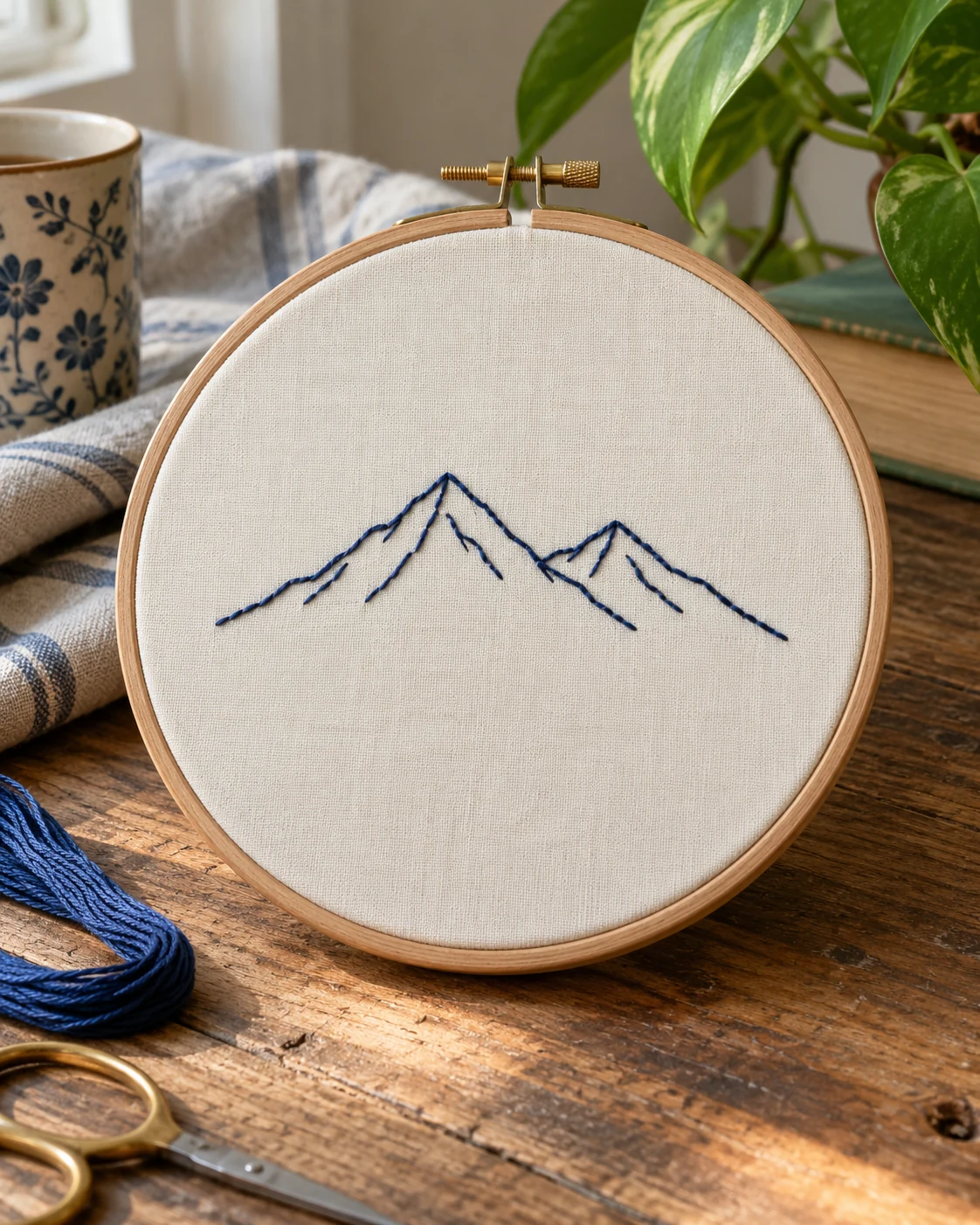 Illustrative concept: backstitch mountain outline.